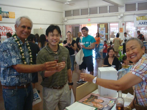 Sen. mike Gabbard, Rep. Jon Riki Karamatsu, and a business representative taking a shot of a healthy mango juice