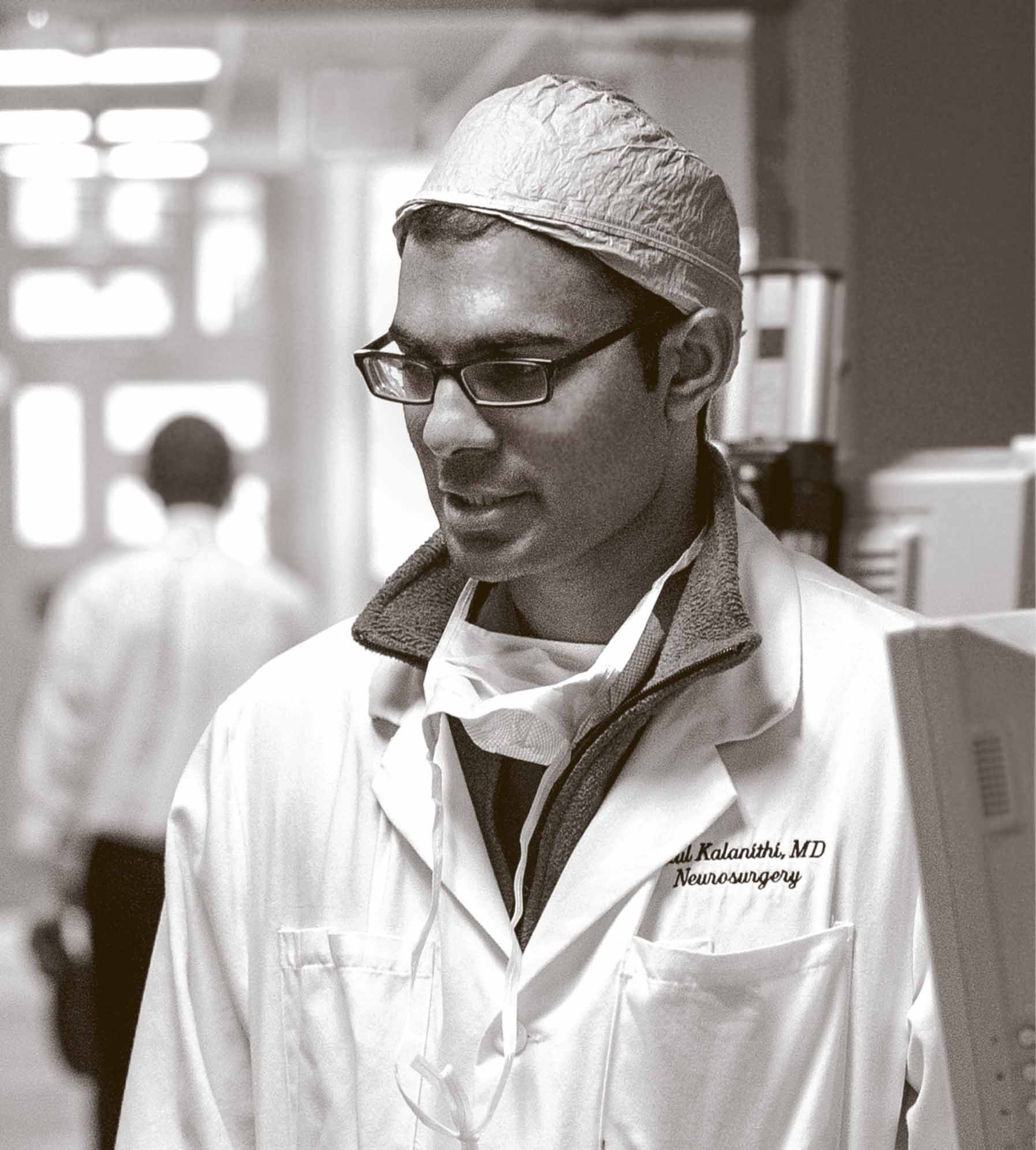 Dr. Paul Kalanithi, a neurosurgeon and neuroscientist, wearing his white coat.